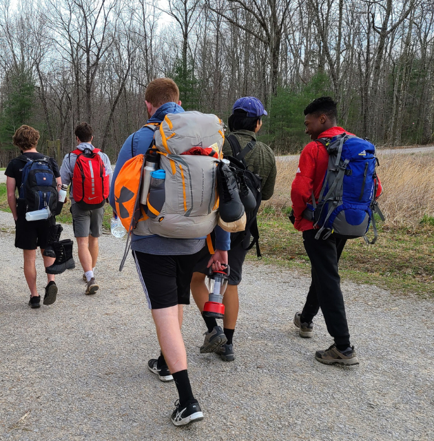 Students hike with backpacks